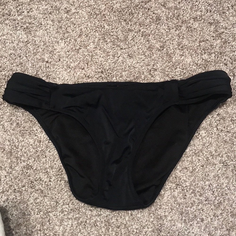 Black Victoria’s Secret swimsuit bottoms
